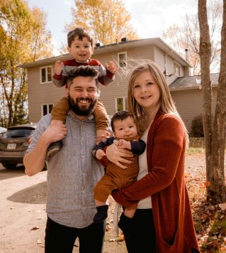 Smiling family of four enjoying a sunny autumn day in their backyard.